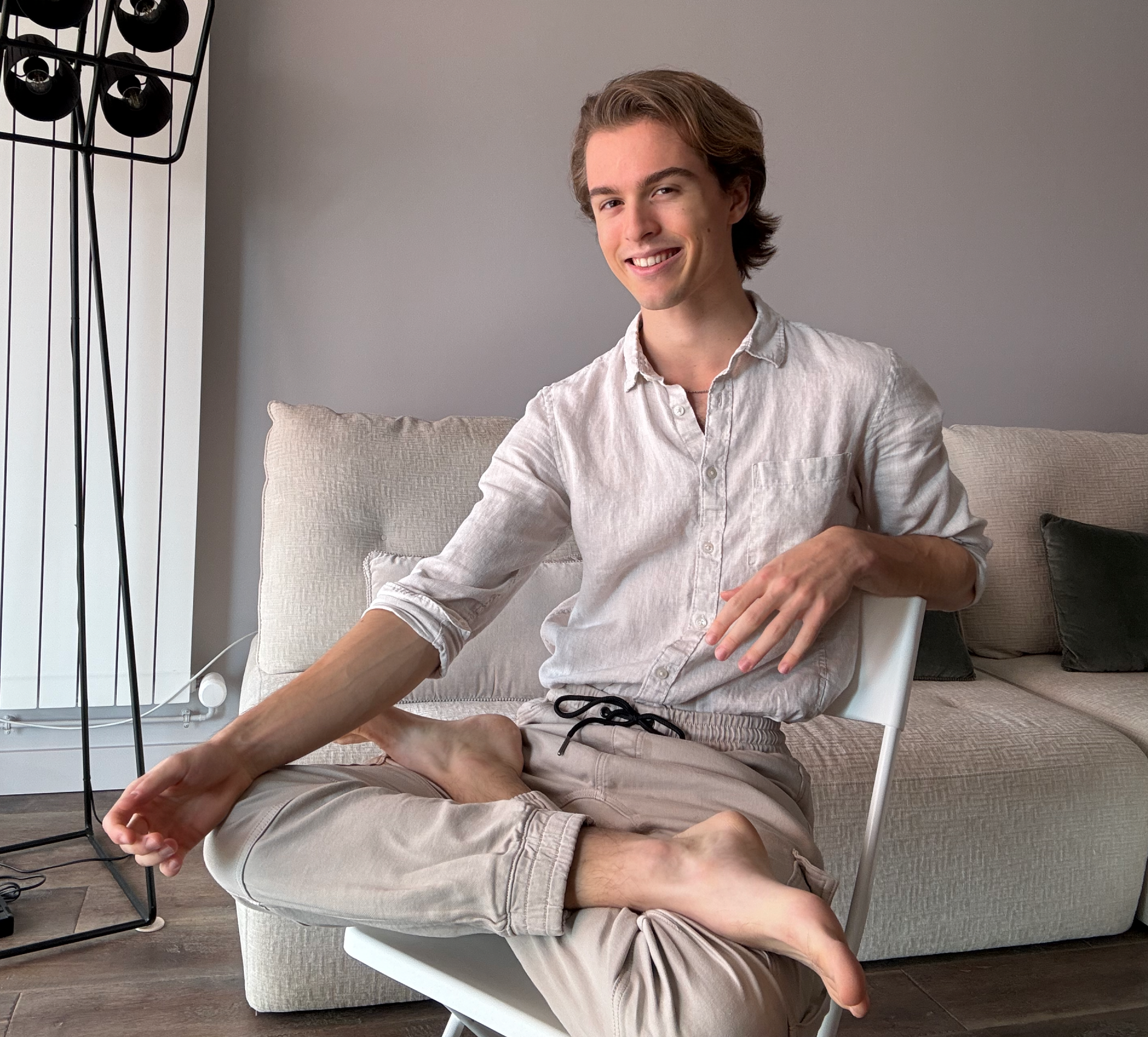 Jules smiling in a white linen shirt